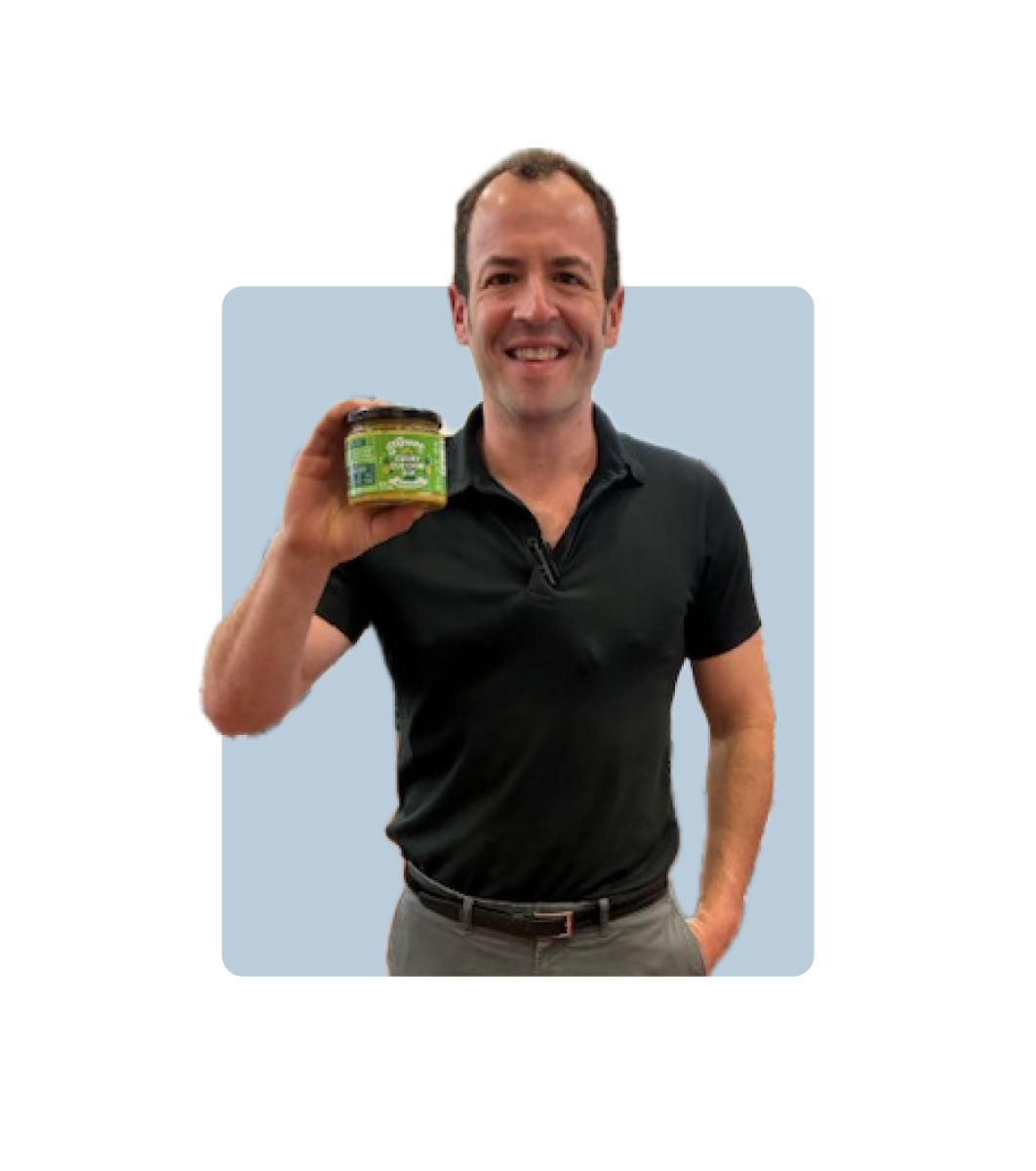 Dougy holding curry zucchini dip in Shubie's february pick of the month photo