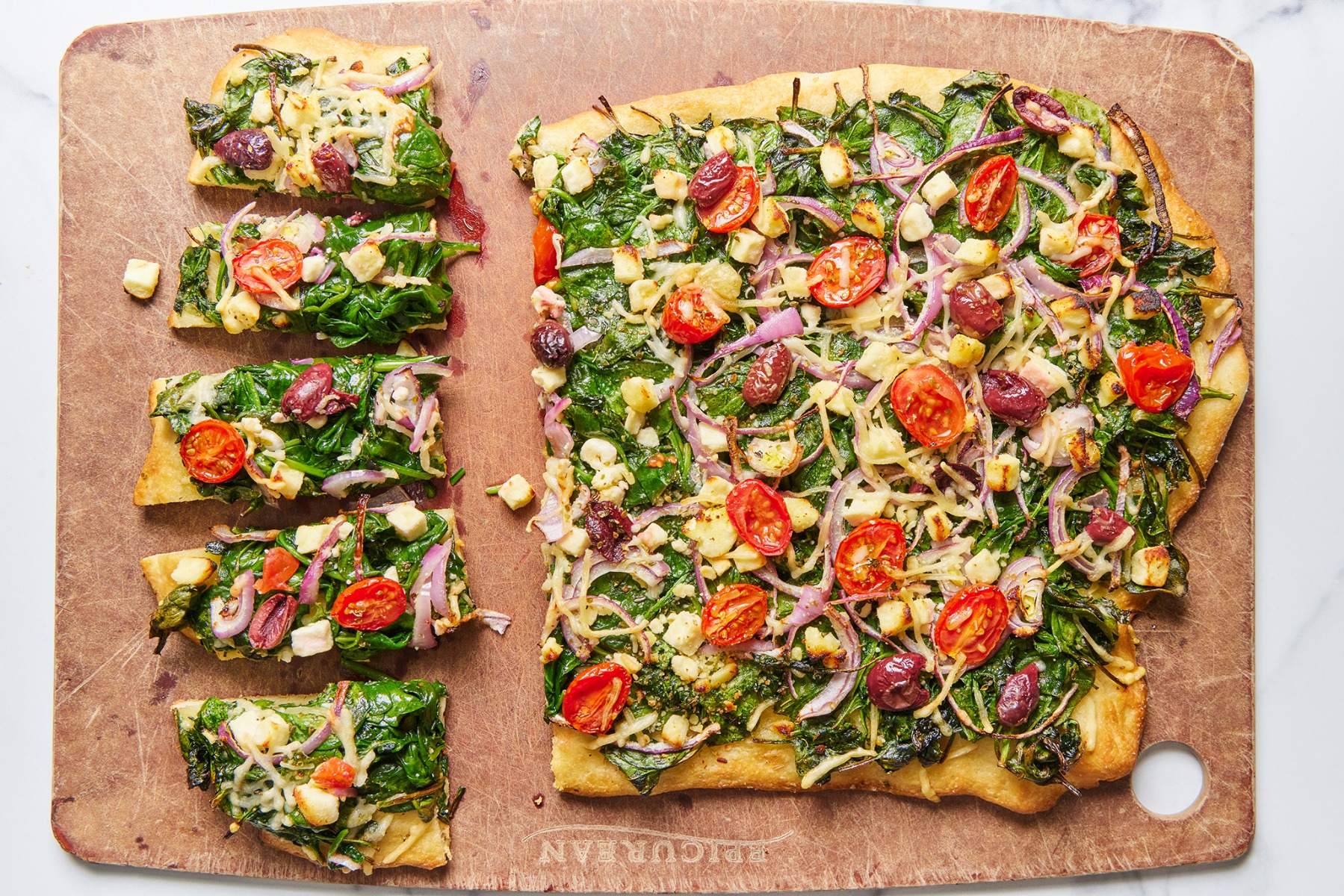 catering plate of foccacia, spinach, olive, feta pizza